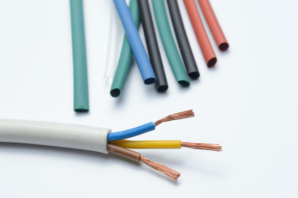 heat shrink tubing and a three-core stripped wire on a white background